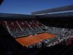 A few spectators lingered in vain hoping for a resumption of power and of play in Madrid. (AP PHOTO)